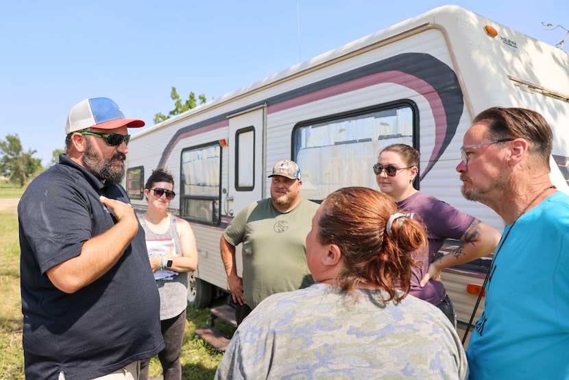 Jamie Hurley (left) with Lone Star Heroes Outdoors, talks to Navy veteran David Vickery,...