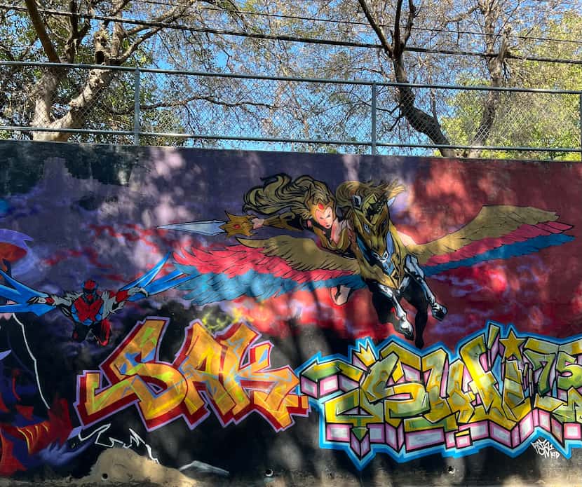 In this piece of the He-Man Wall, DAP painted the character at the top and two other...