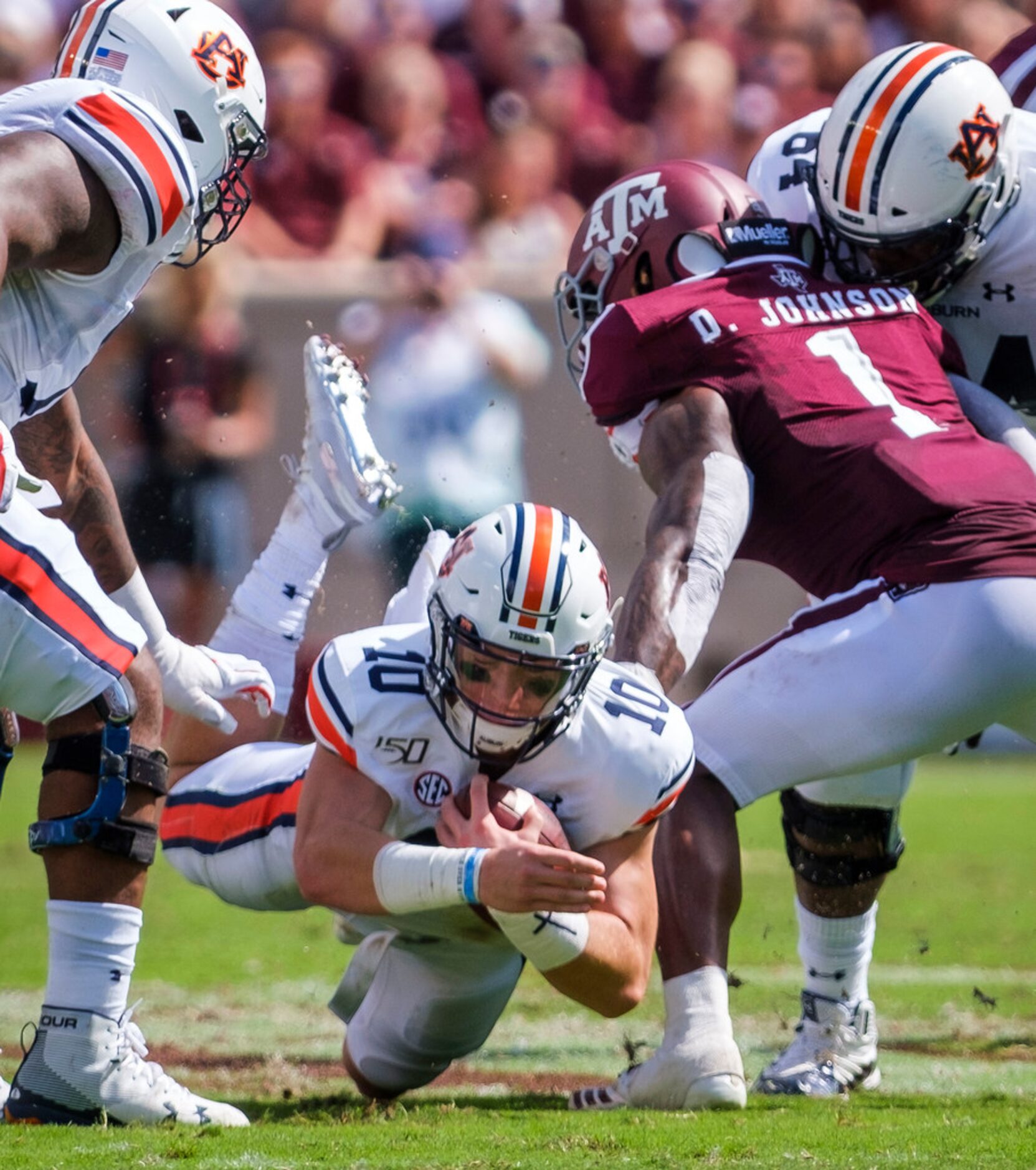 Auburn quarterback Bo Nix (10) dives for extra yardage past Texas A&M linebacker Buddy...