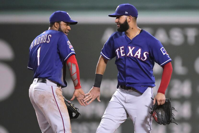 Texas Rangers' Elvis Andrus, left, and Nomar Mazara celebrate after defeating the Boston Red...