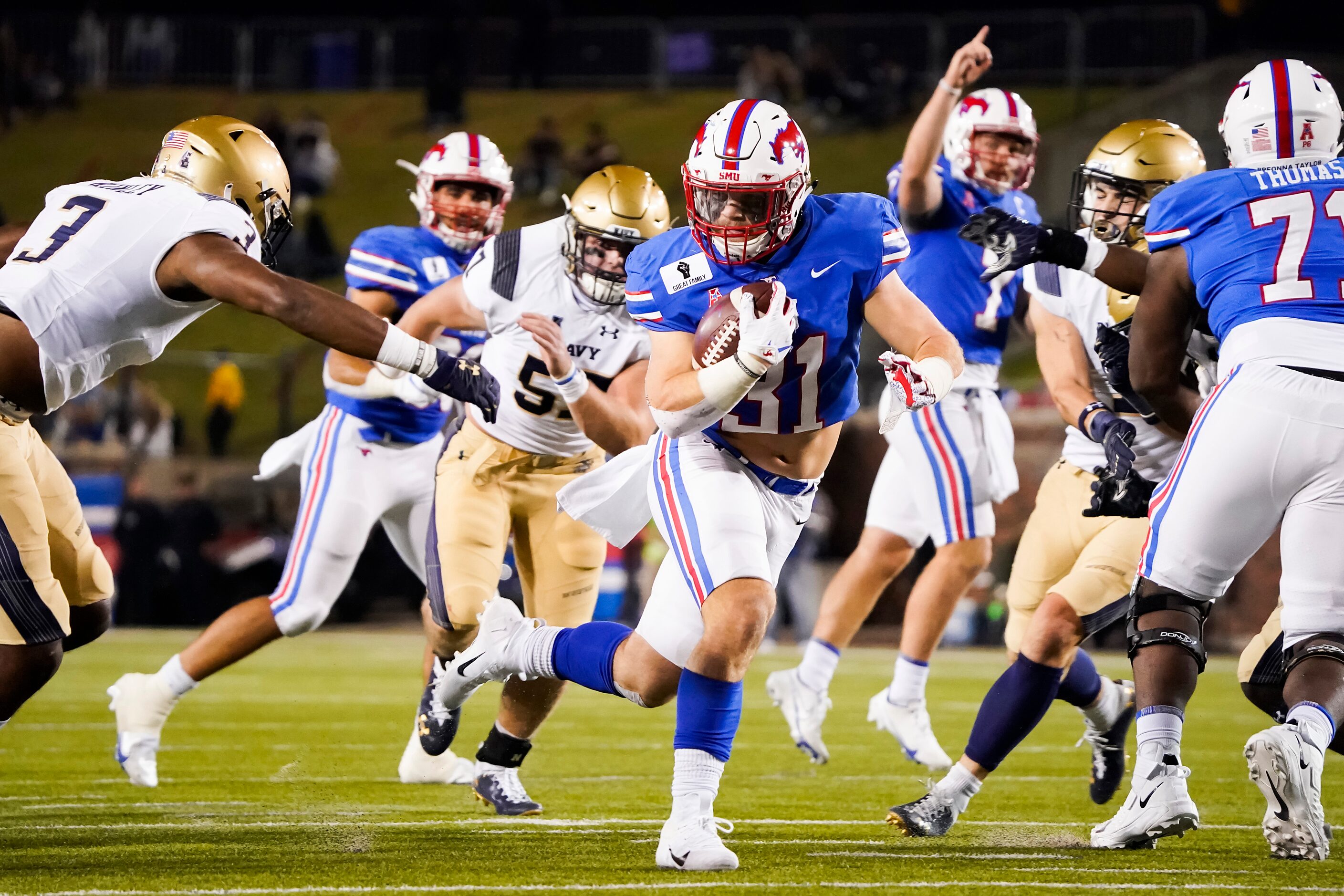 SMU running back Tyler Lavine (31) gets past Navy cornerback Cameron Kinley (3) for a...