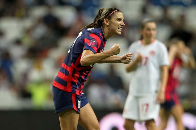 United States' Alex Morgan celebrates scoring her side's opening goal from the penalty spot...