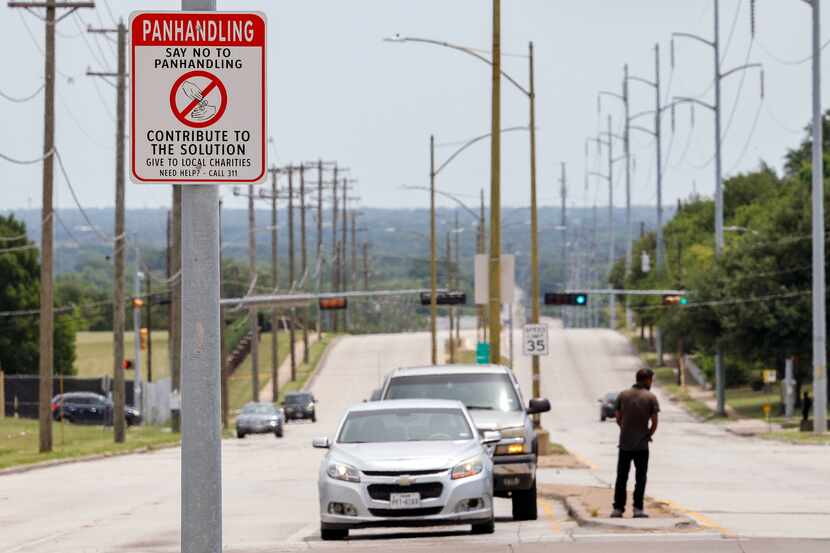 A sign encourages people not to support panhandling near the intersection of Simpson Stuart...