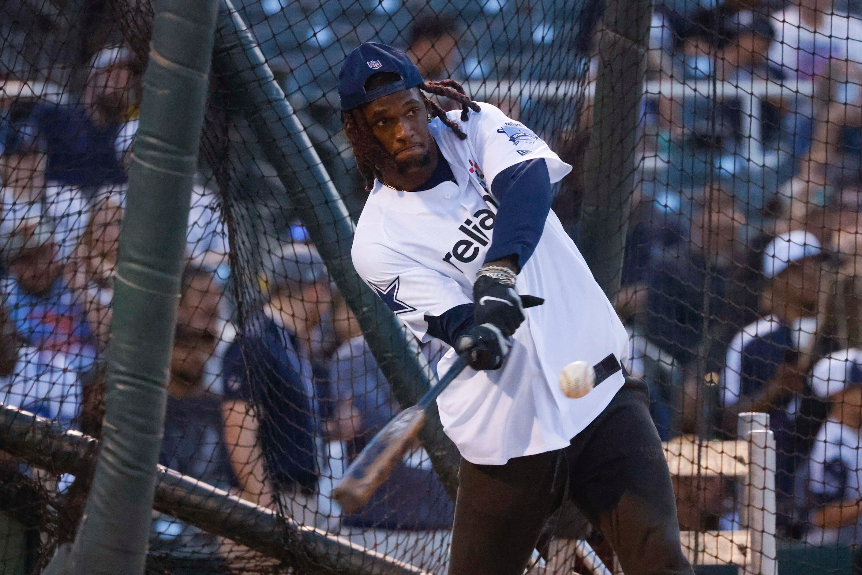 Dallas Cowboys wide receiver CeeDee Lamb (left) hits during the annual home run derby ...