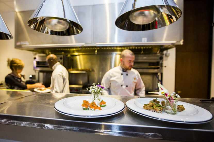 Hors d'oevres are prepared by chefs at Cafe Momentum during their grand opening on Tuesday,...