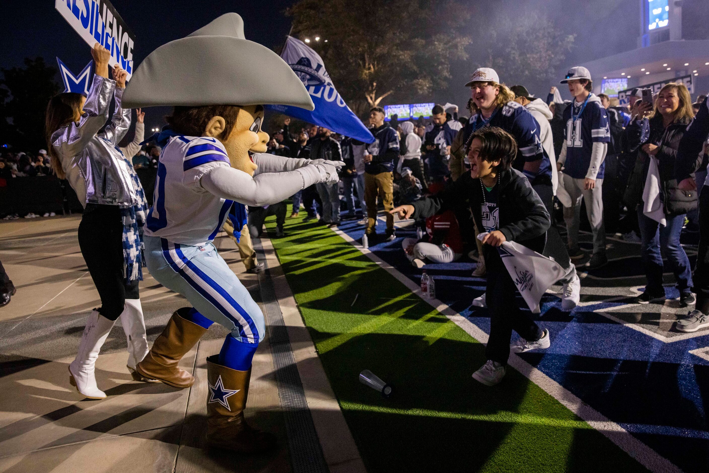 Rowdy celebrates with Joseph Ovalle, 11, after a Dallas Cowboys play against the San...