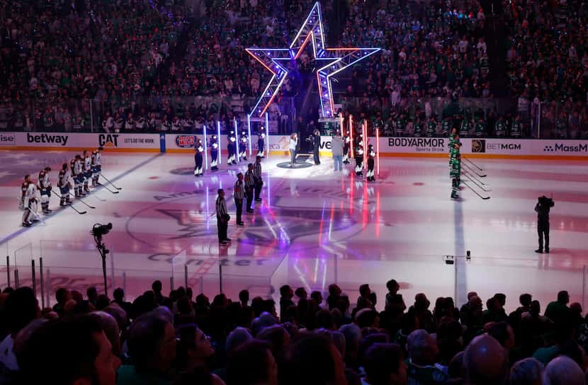 Players line up for the national anthem during the first period in Game 5 of an NHL hockey...