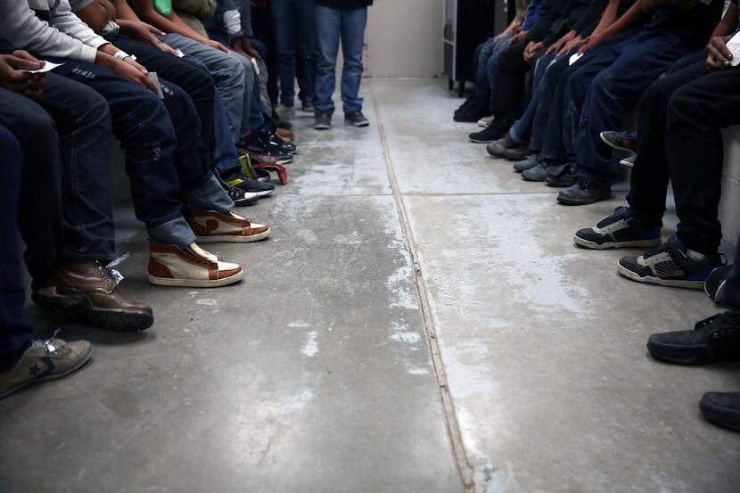 Immigrants caught trying to unlawfully enter the United States waited in detention in...