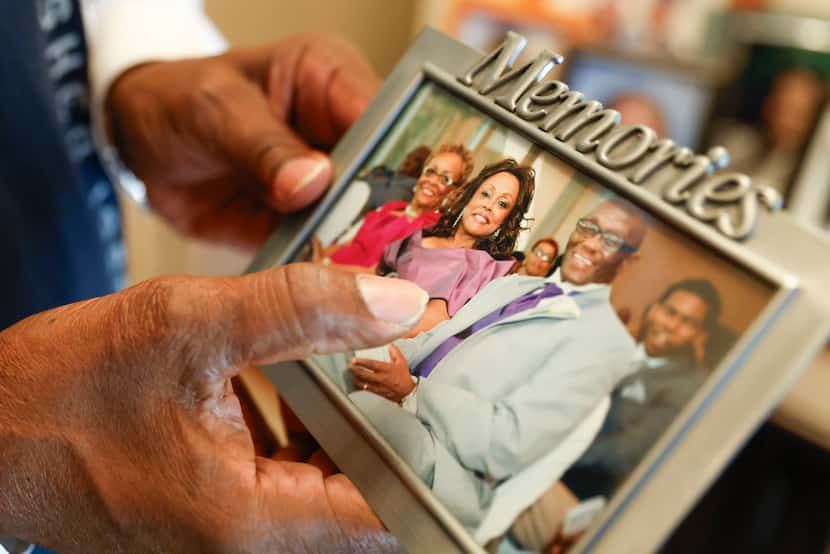 Rick Jordan holds a family photo of himself, his wife, Sandra, (center) and Sandra's sister...