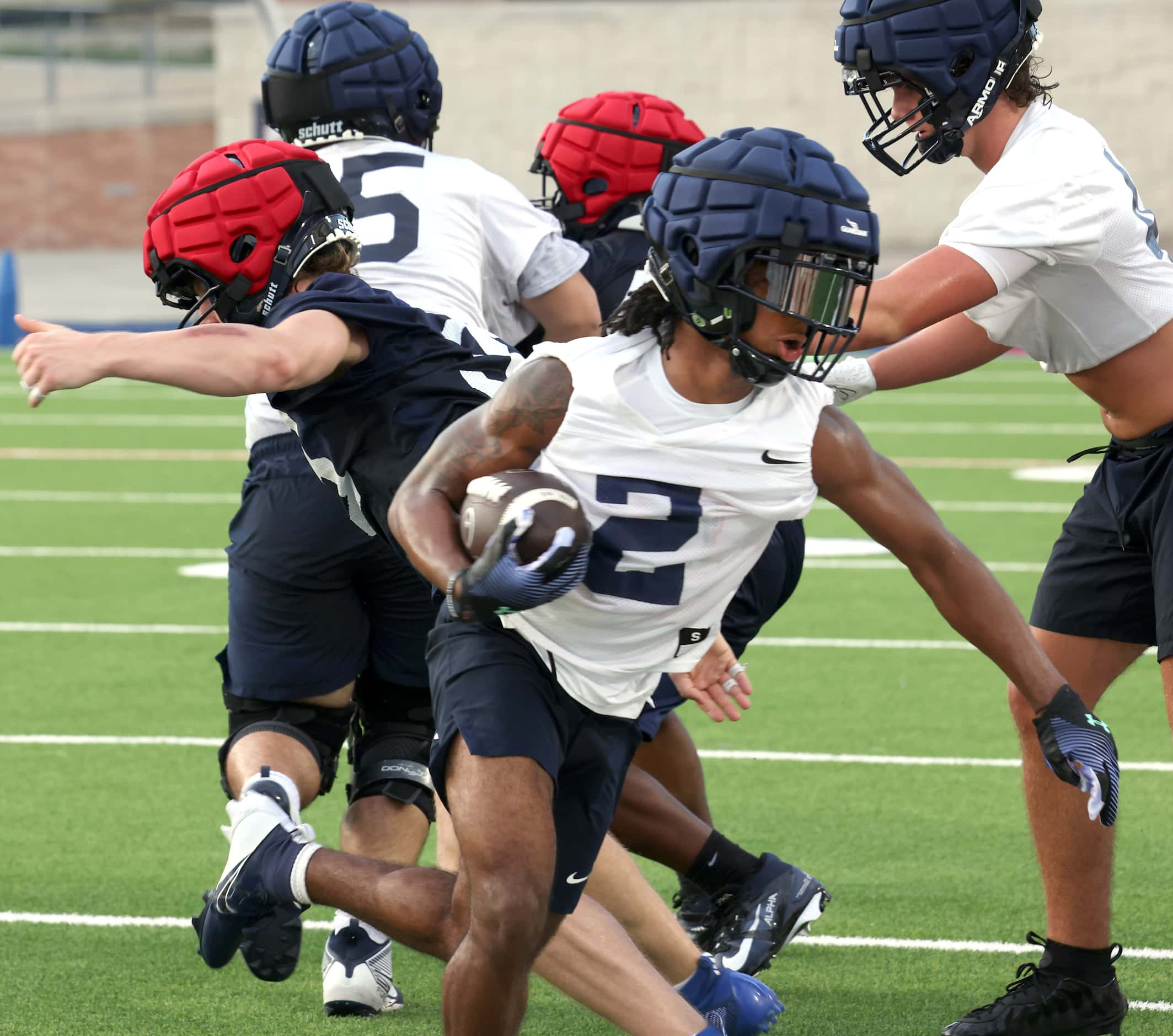 Allen senior running back Micah Ellis (2) breaks through a hole created by his offensive...