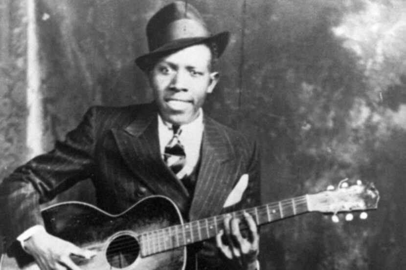 A 1935 photo shows blues guitarist and singer Robert Johnson, whose historic recordings in...
