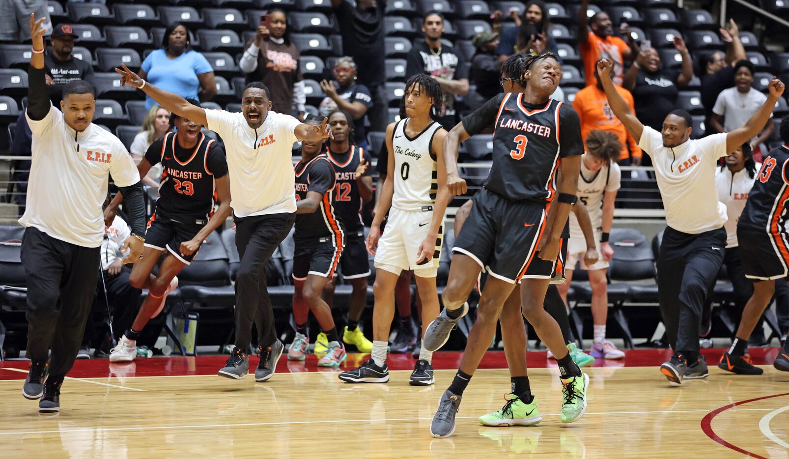 Lancaster coaches and players celebrate, including Lancaster head coach Ferrin Douglas...