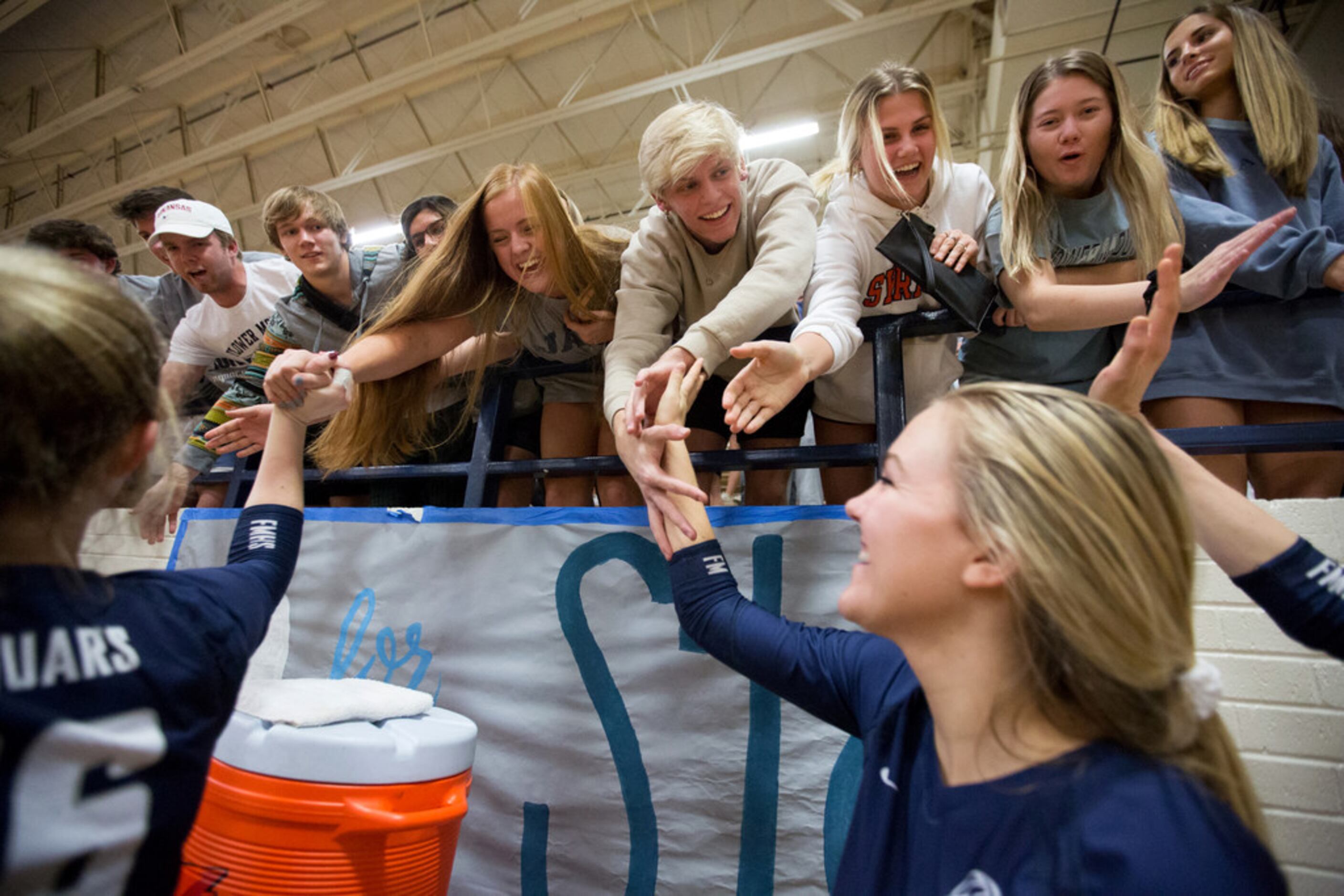 Flower Mound volleyball players greet fans after defeating Keller High School on Monday,...