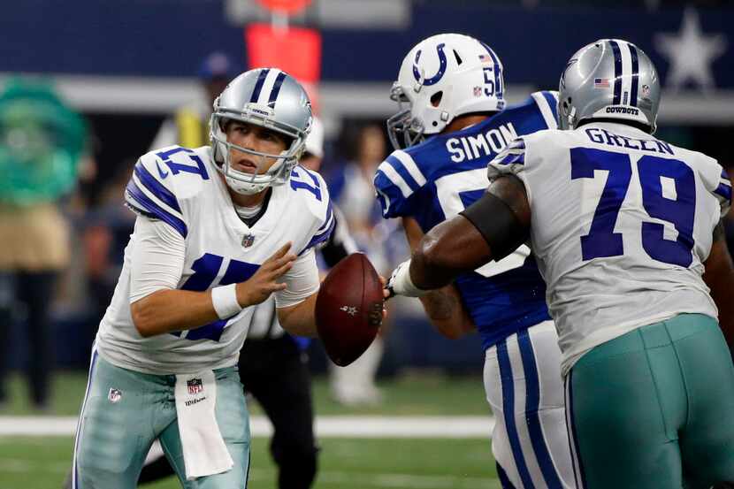 Dallas Cowboys quarterback Kellen Moore (17) scrambles out of the pocket as offensive tackle...