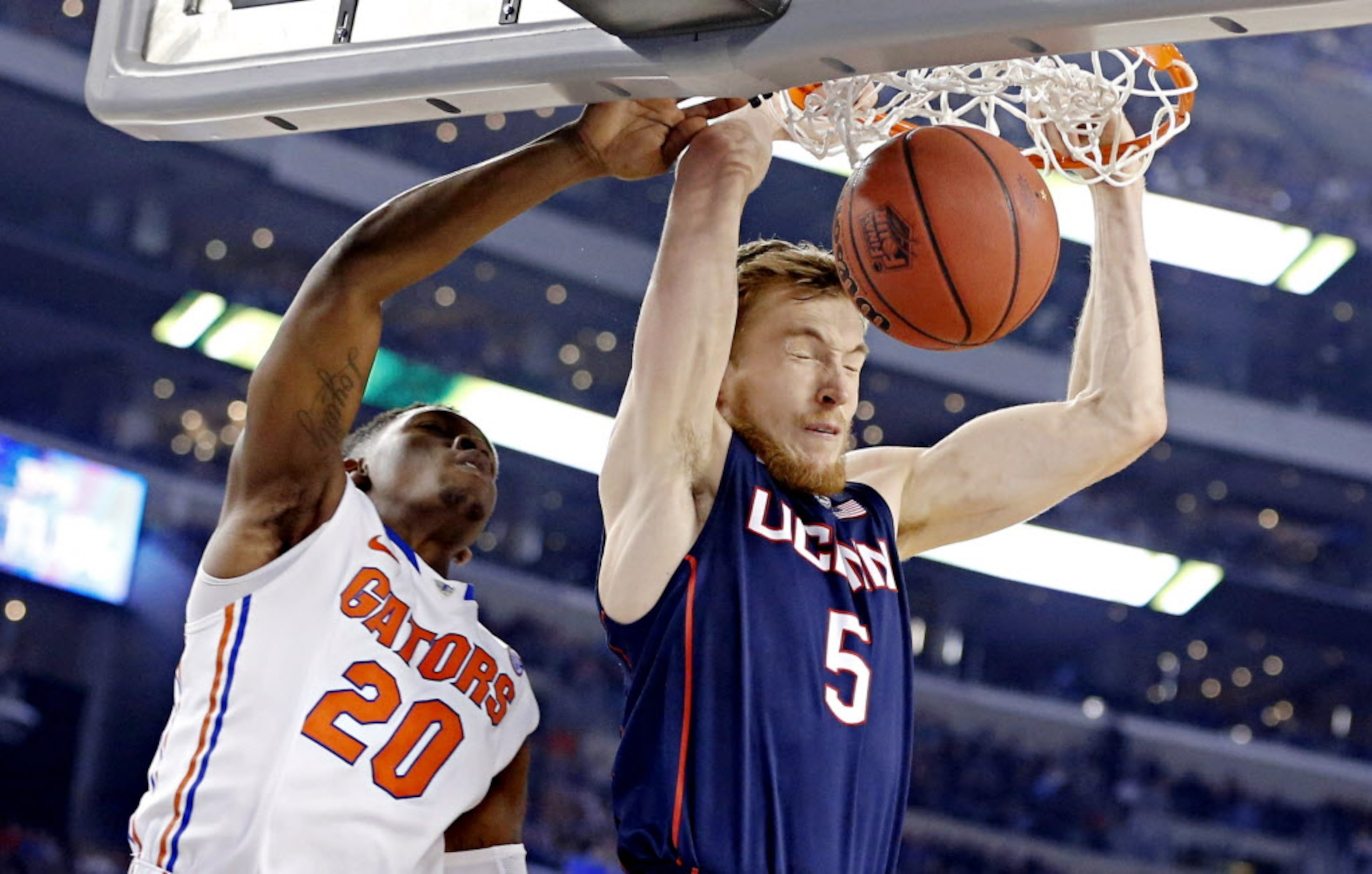 Connecticut Huskies guard/forward Niels Giffey (5) gets past Florida Gators guard Michael...