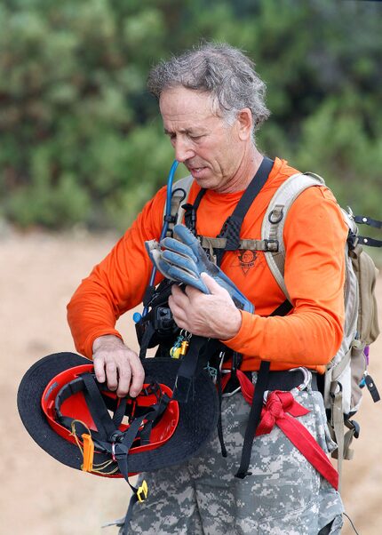 A member of the Tonto Rim Search and Rescue team gathers his gear during an operation along...