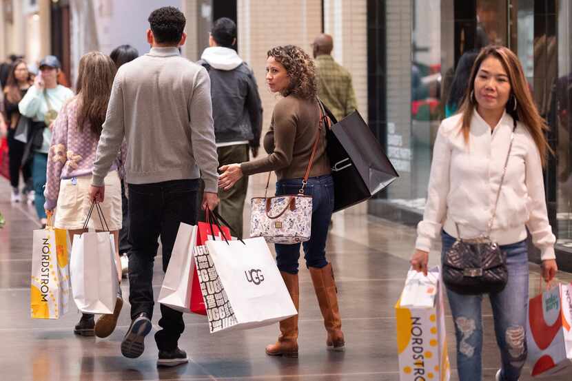 Shoppers carry bags and look confident about their mission at NorthPark Center in Dallas.