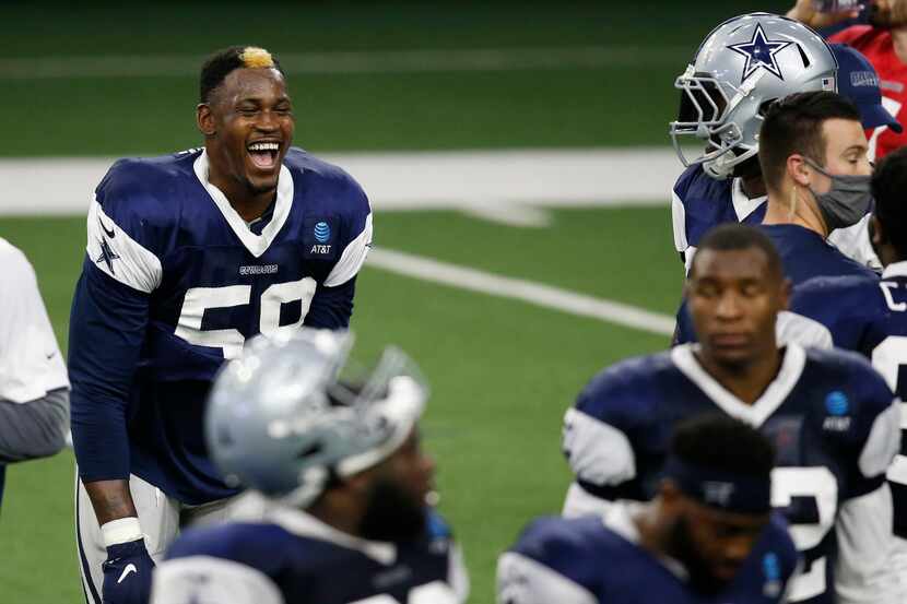 Dallas Cowboys defensive end Aldon Smith (58) laughs as he talks with Dallas Cowboys...