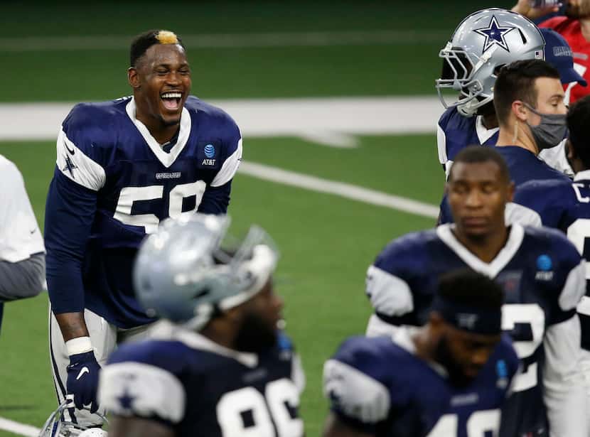 Dallas Cowboys defensive end Aldon Smith (58) laughs as he talks with Dallas Cowboys...