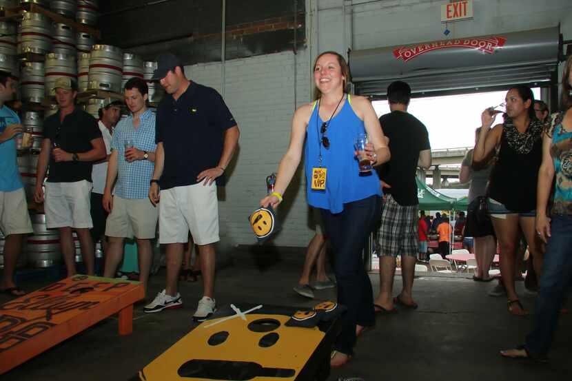 People play cornhole at Deep Ellum Brewing Co. 