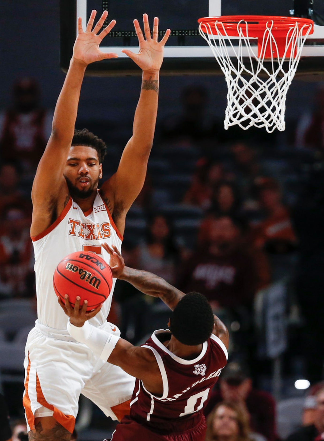 Texas Longhorns forward Royce Hamm Jr. (5) guards Texas A&M Aggies guard Jay Jay Chandler...