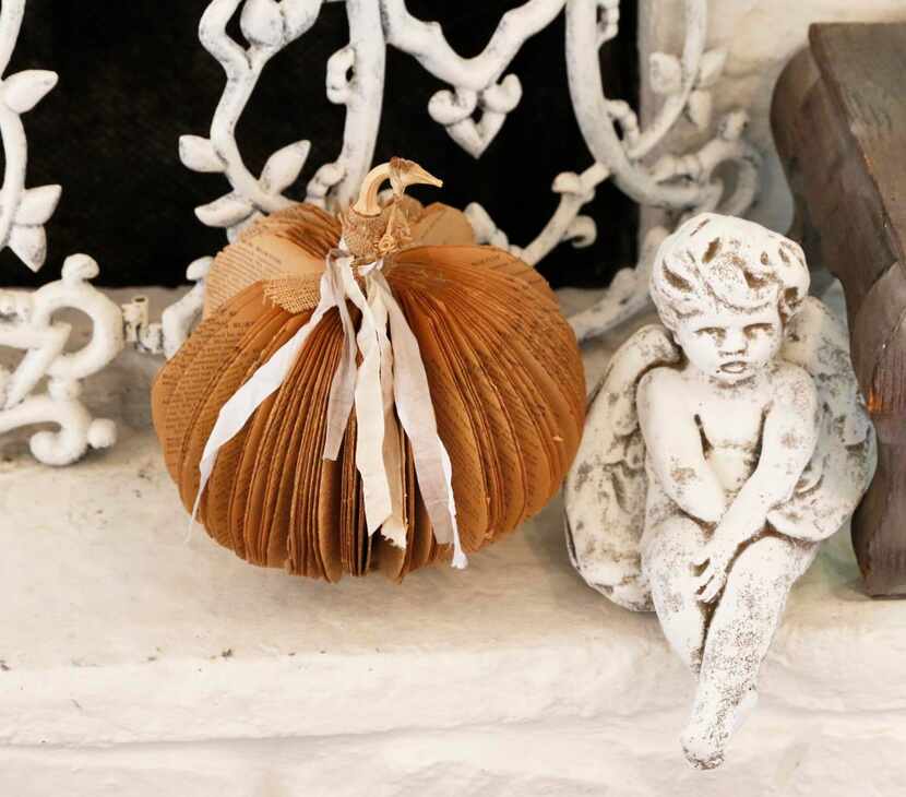 
One of the traditional fall elements Young uses is a pumpkin made from old book pages,...