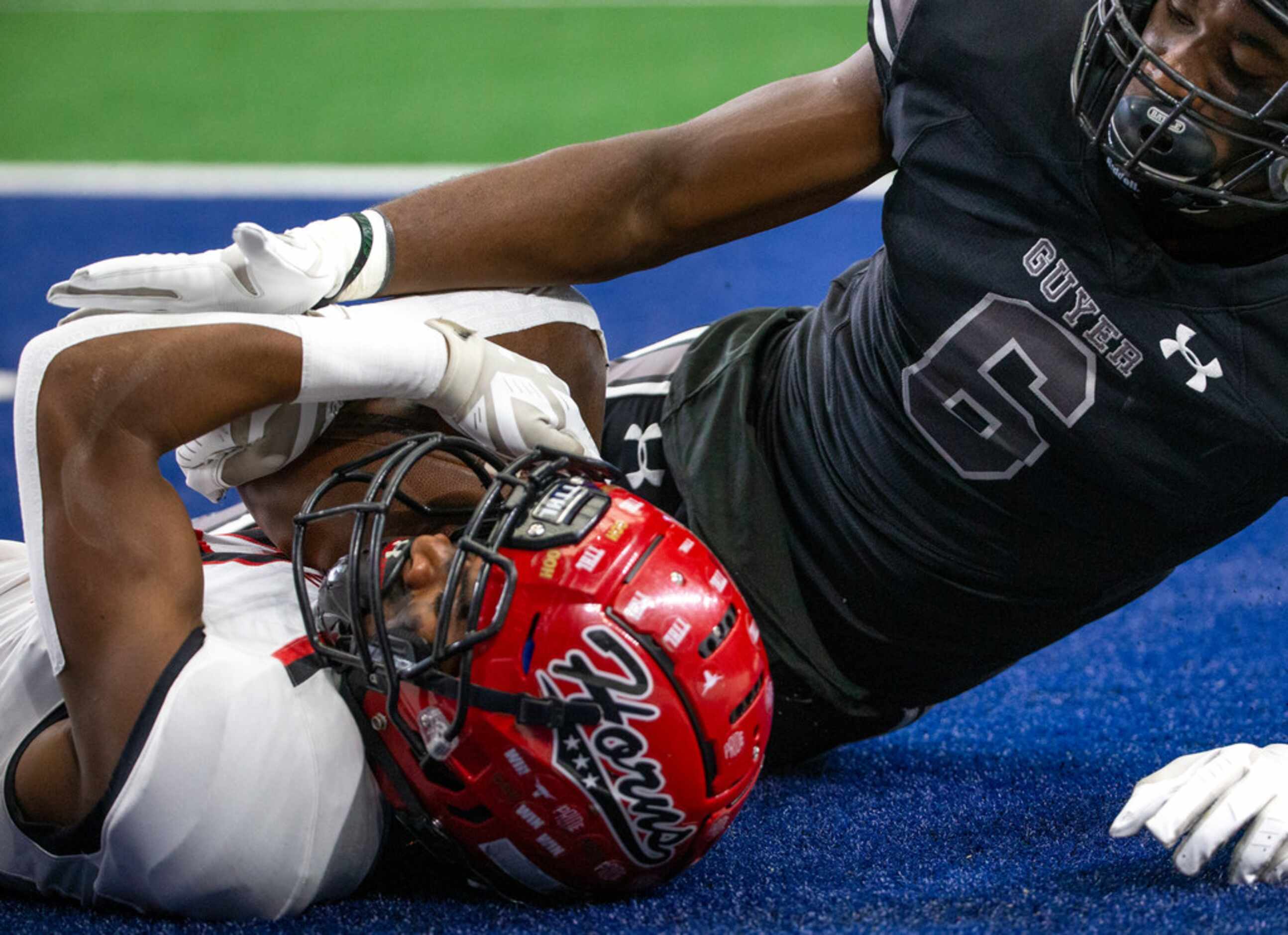 Cedar Hill wide receiver Brian Rainey (left, 12) lies in the endzone after scoring against...