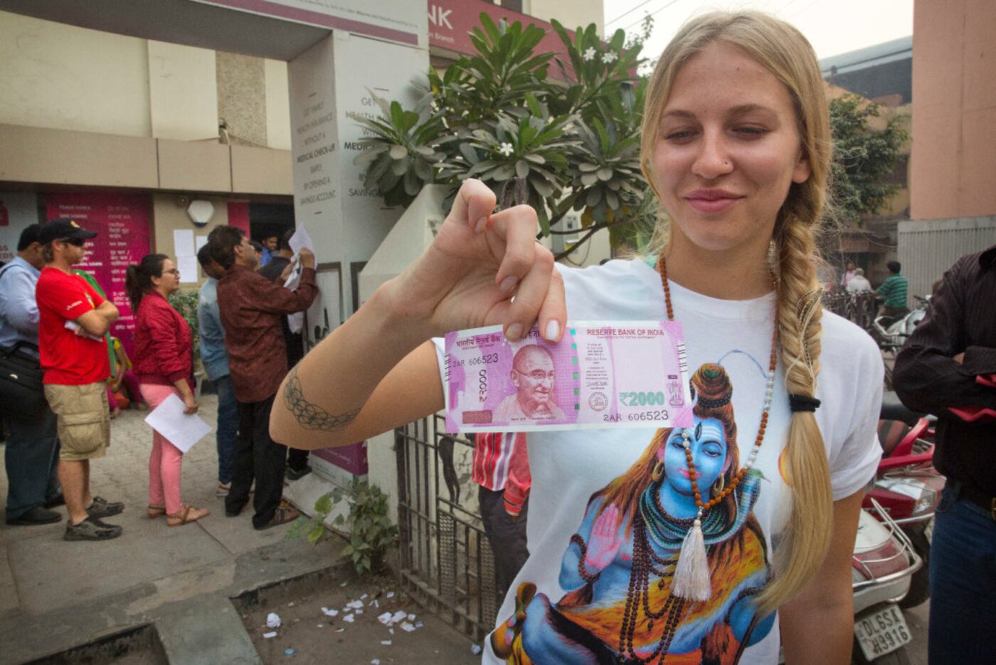 A Russian tourist shows a new rupees 2000 note currency she receievd after getting it...