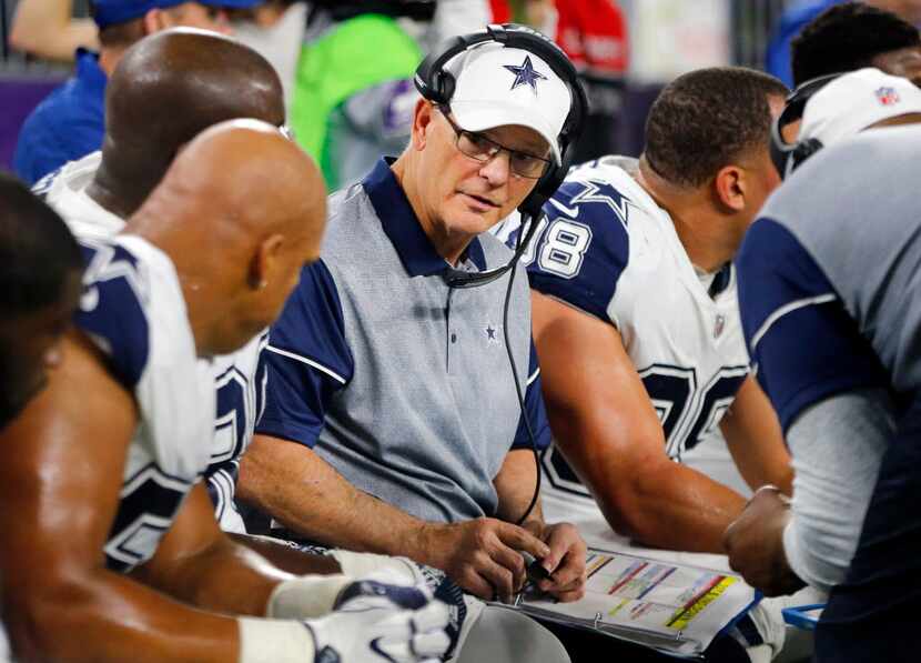 Dallas Cowboys defensive coordinator Rod Marinelli (center) visits with his players on the...