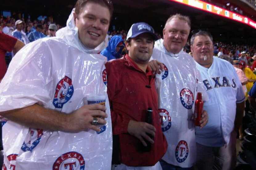 Joshua Harbuck (left) at a Texas Rangers game with his father, Hal Jay (second from right)....
