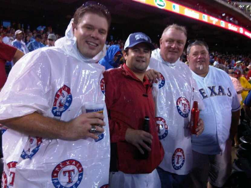 Joshua Harbuck (left) at a Texas Rangers game with his father, Hal Jay (second from right)....