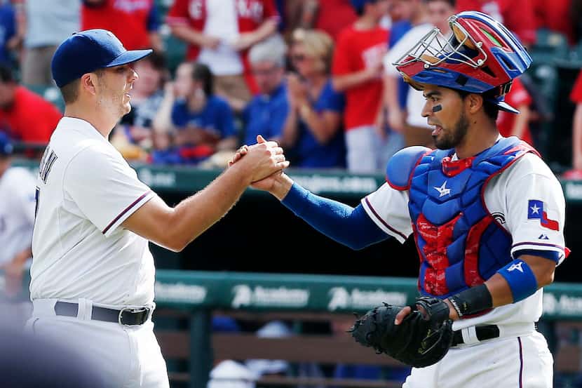 Texas Rangers relief pitcher Shawn Tolleson, left, and catcher Robinson Chirinos celebrate a...