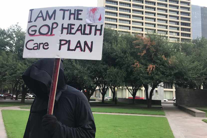 Cary Clark of Fort Worth dressed as the grim reaper for a protest opposing Texas' attempts...