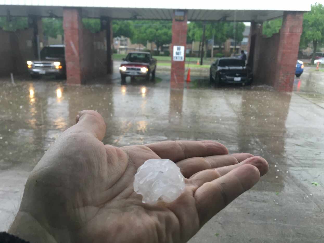 Hail falls at a car wash in Irving on Friday evening.