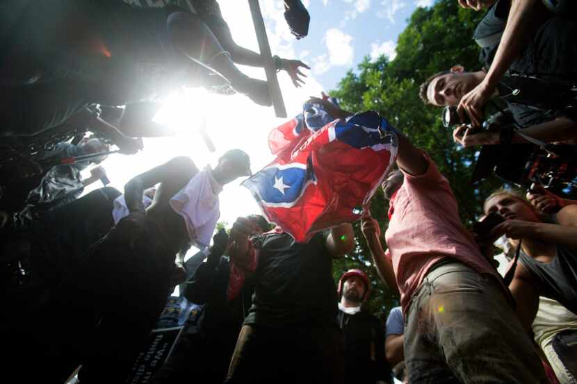 Counter-protesters tear a Confederate flag during a white nationalist rally, on Saturday...