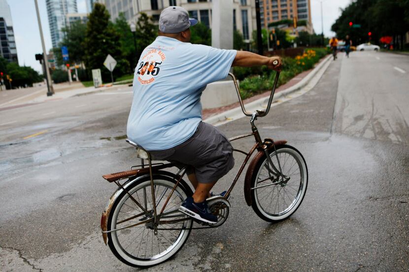 Jose Gomez Jr., 33, of the bicycle club Slow Spokes DFW, sports a classic rusty bicycle that...