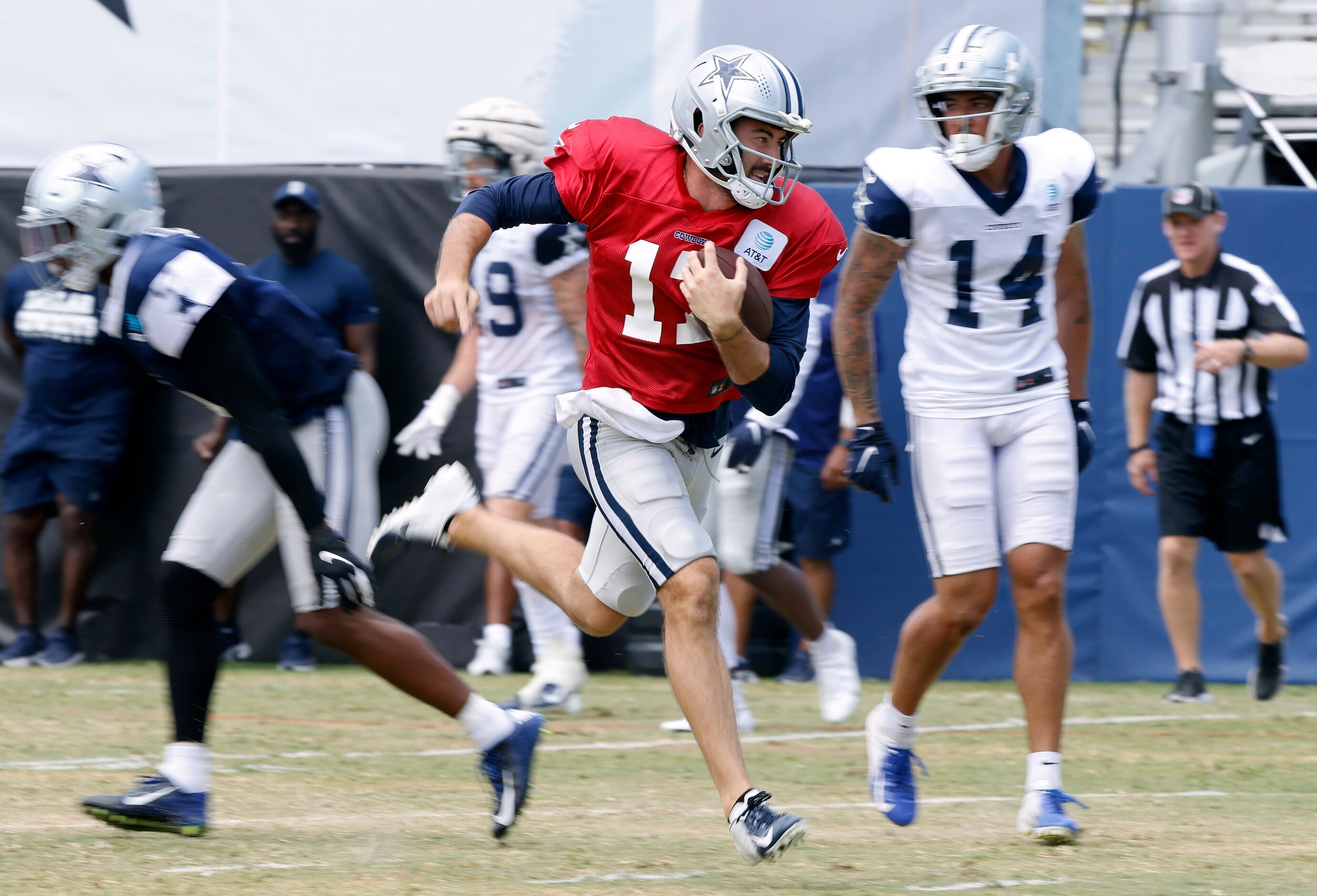 Dallas Cowboys quarterback Ben DiNucci (17) carries the ball after opting not tot pass...