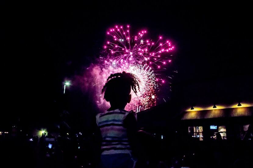 Justice Grant sits on her moms shoulders for a great view of the fireworks at Kaboom Town in...