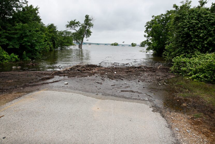 A road that usually leads to a boat ramp at a closed Murrell Park on the north shore of...