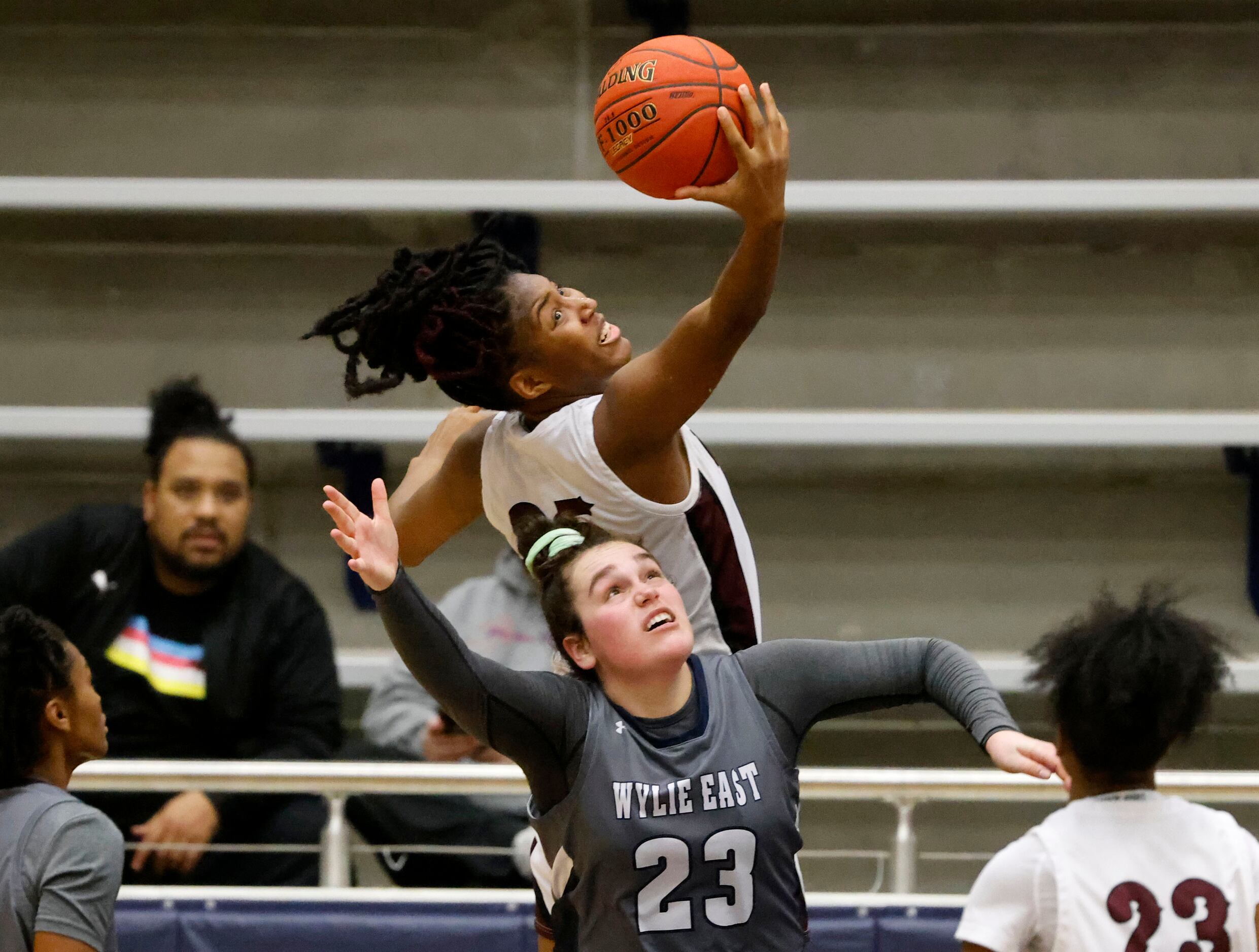 Red Oak’s Aniyah Johnson (35) grabs a rebound and is fouled by Wiley East’s Kiley Hicks (23)...