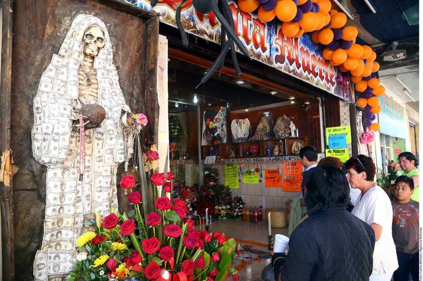A Santa Muerte altar in Mexico City. La Santa Muerte is an underworld folk saint associated...