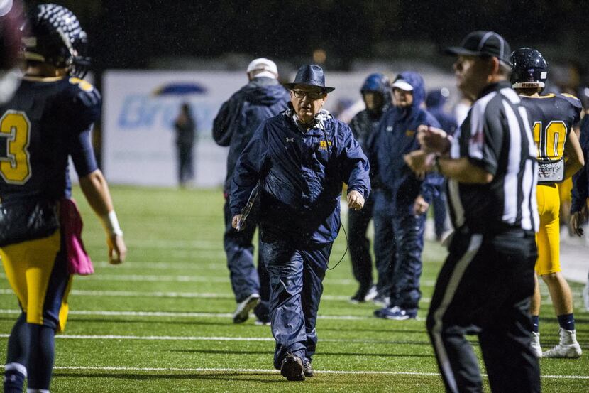 Highland Park head coach Randy Allen tells his players to come off the field after a...