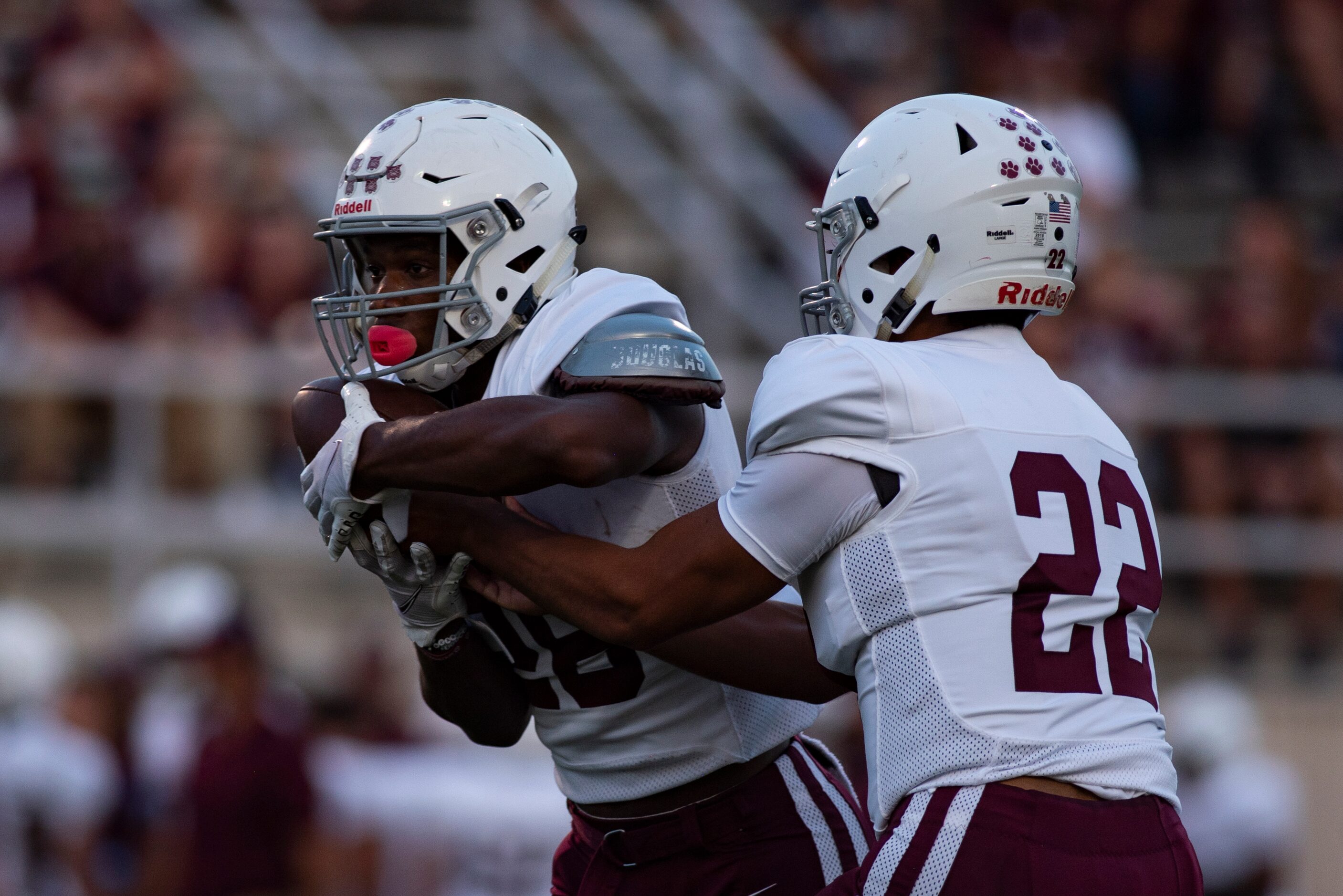 Plano Senior High School senior Grant Garcia (22) hands the ball off to Plano Senior High...