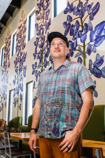Artist Dan Black painted bluebonnets on the walls at the new LSA Burger Co. in The Colony.