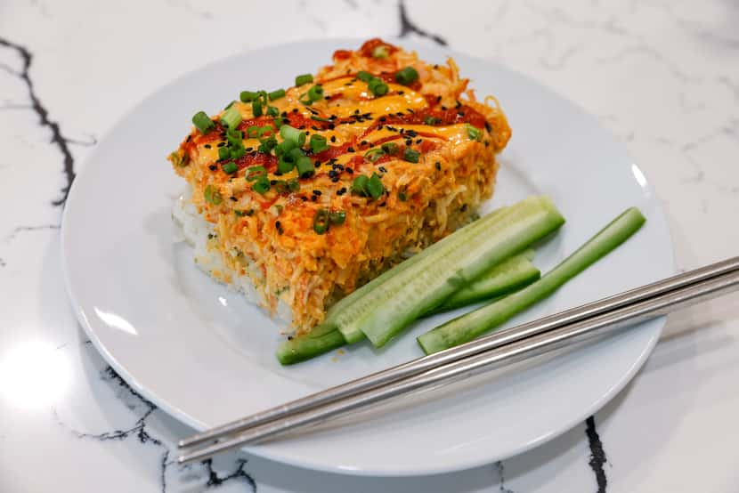 A piece of sushi bake, a casserole of salmon, imitation crab and rice.