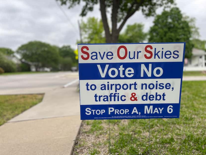 Signs along West Louisiana Street in McKinney urge people to vote against McKinney National...