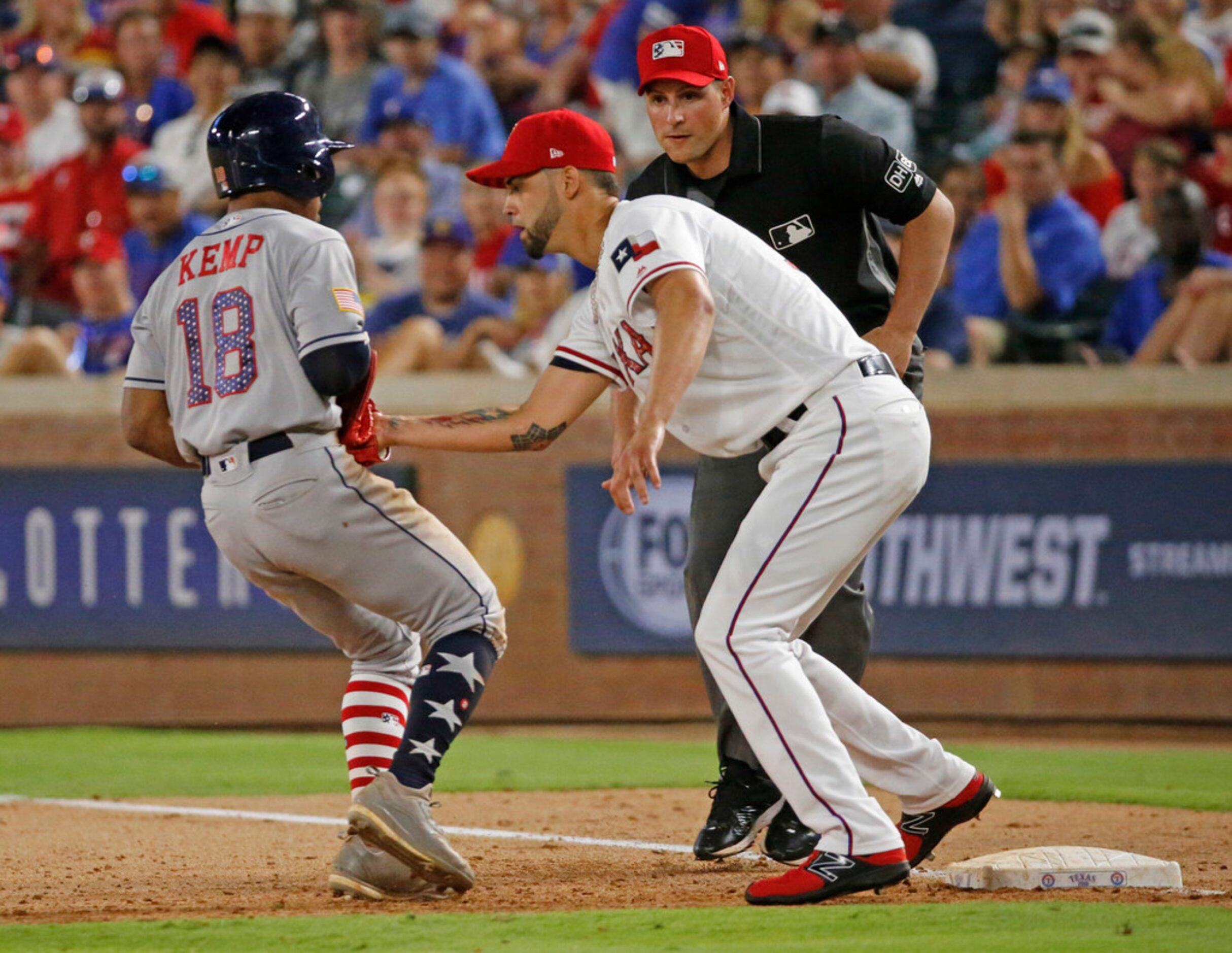 Texas Rangers relief pitcher Alex Claudio (58) tags out Houston Astros baserunner Tony Kemp...