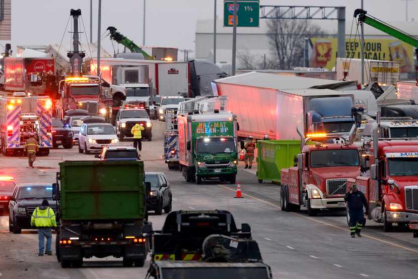 Crews are shown working the crash area on Interstate 35W in Fort Worth on Feb. 11, 2021. Six...