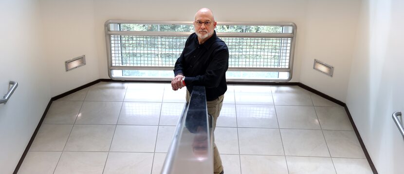 Sidney Thompson poses in Dave Reed Hall outside his campus office. The author and TCU...