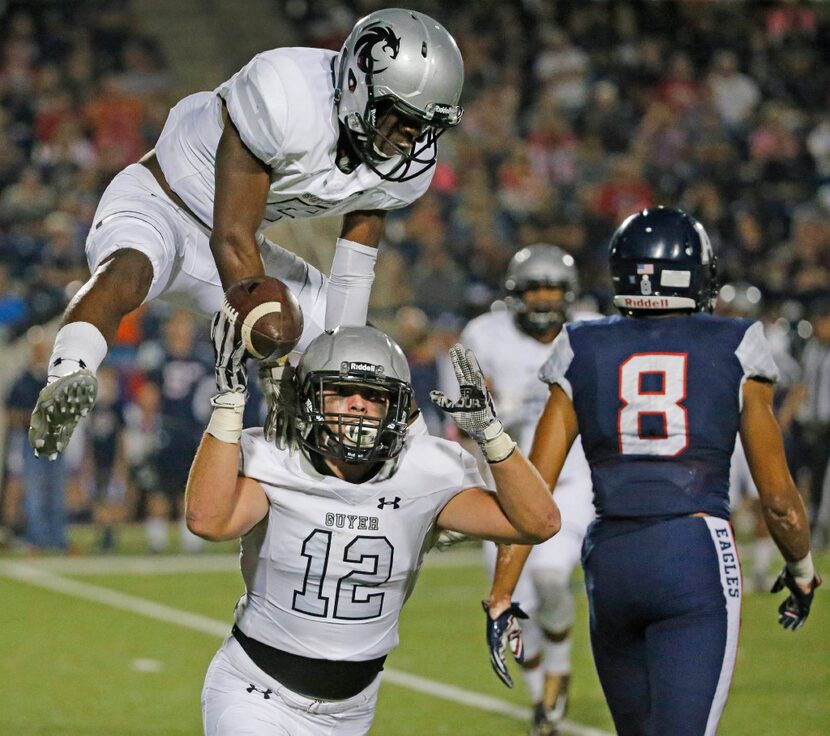 Guyer defender Tucker Notary (12) celebrates his first-quarter interception with teammate ...